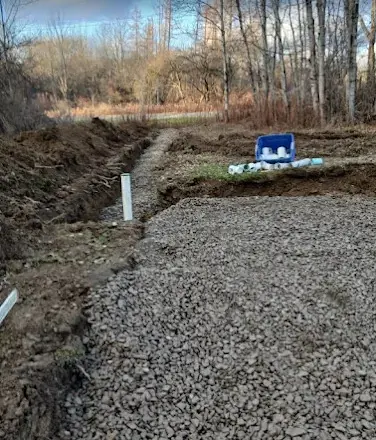 Septic distribution box set in a gravel trench with riser during a Landmark Enterprises septic installation in Chautauqua County, NY