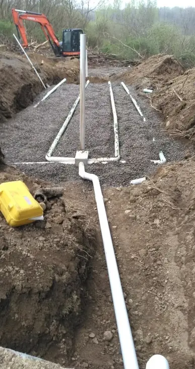 Septic drain field installation with PVC laterals in a gravel bed and distribution pipe, Chautauqua County, NY
