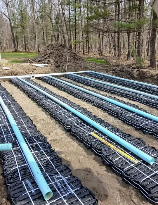 Landmark Enterprises septic leach field installation in Chautauqua County, NY — infiltrator chambers and PVC laterals set in sand
